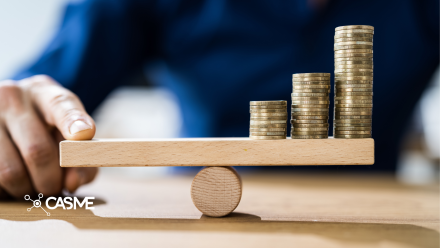 Man balancing coins on a wooden plank