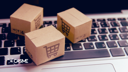 Image of small delivery boxes resting on a computer keyboard